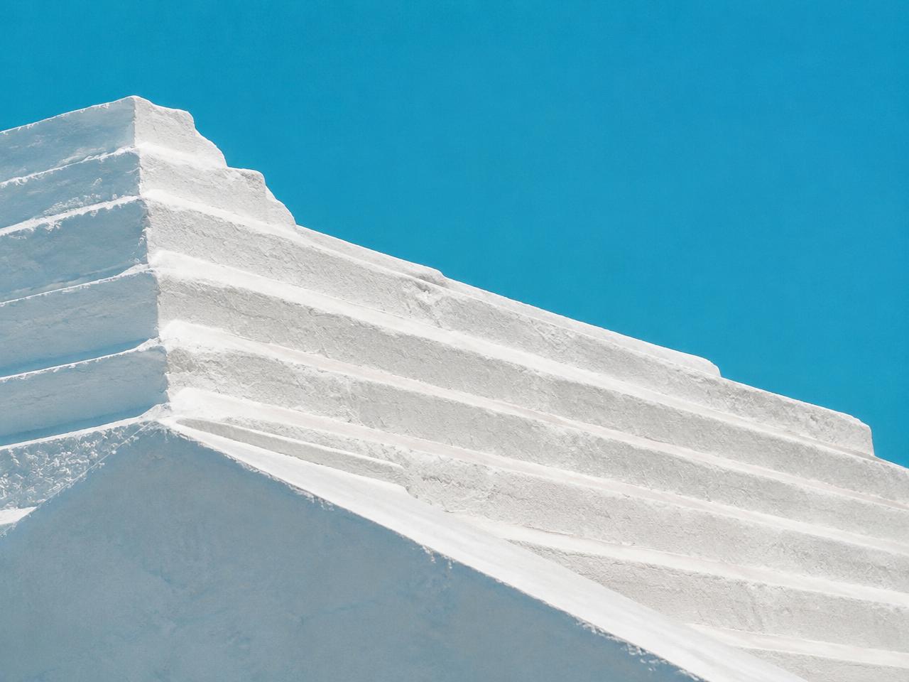 White stepped Bermuda roof against a clear blue sky